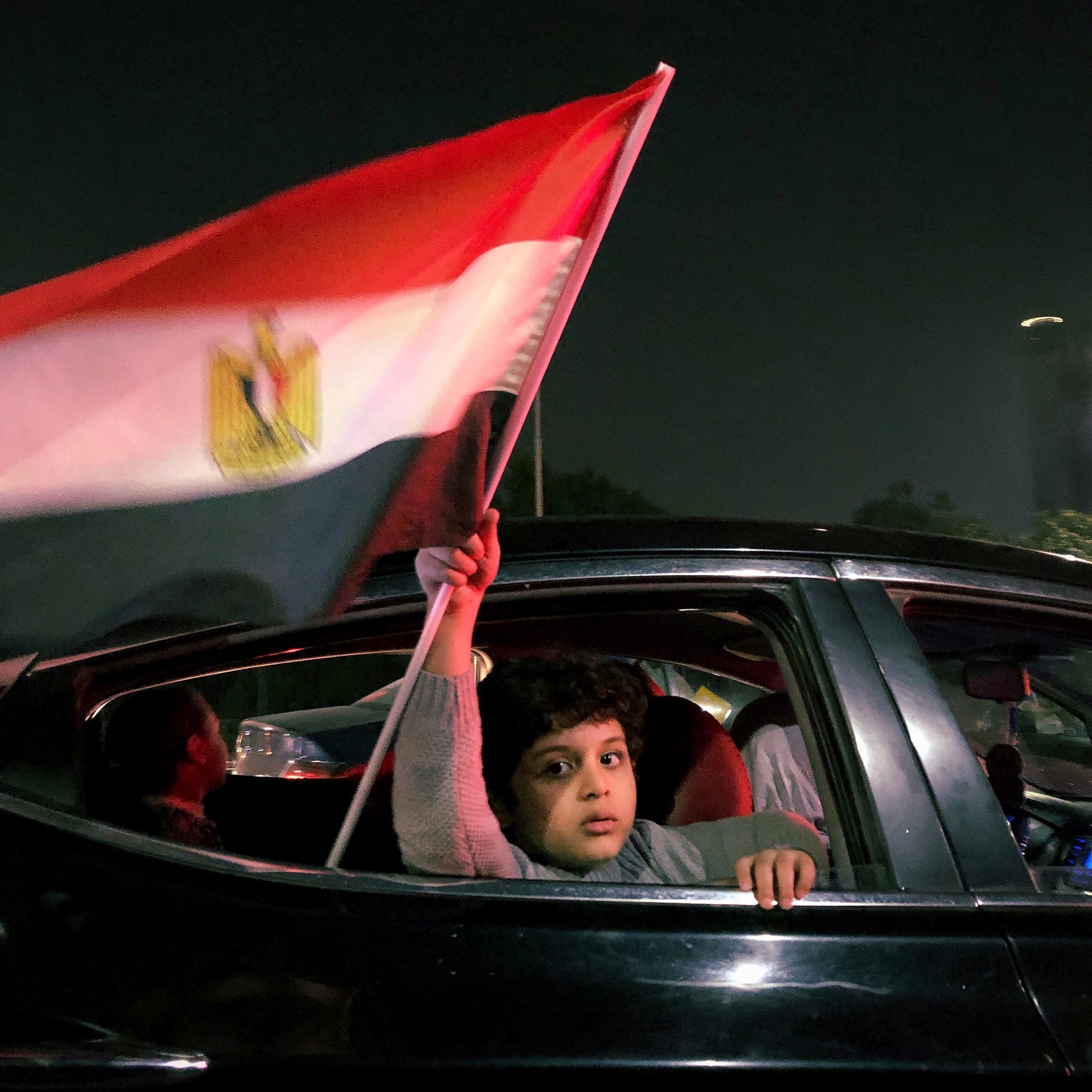 A boy holds an Egyptian flag as a celebration after Al- Ahly club winning the African champions league.